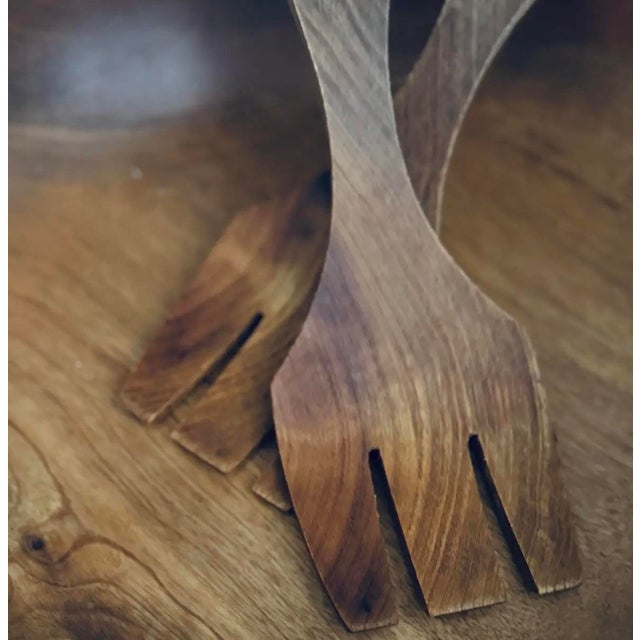 Beautifully hand-turned 1960s Danish teak salad bowl with matching sculpted fork and spoon servers. Warm organic tone,...