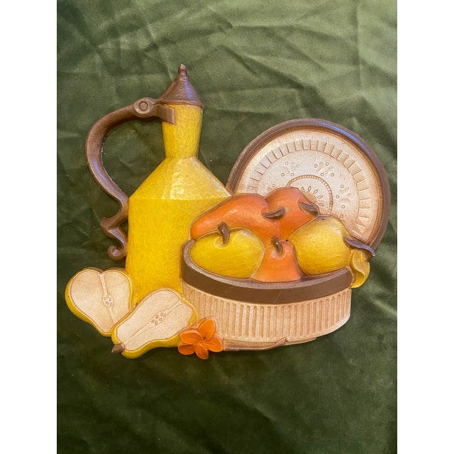 This pair of retro 1981 summer/autumn fruit & flower wall plaques was produced by Homco SYROCO, INC. The jug and pears...