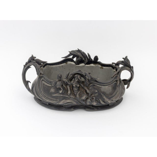Art Nouveau Fairy Amongst Lily Flowers Pewter Jardiniere, with fitted liner. 6" H x 15" W x 9" D. Provenance: From a West...