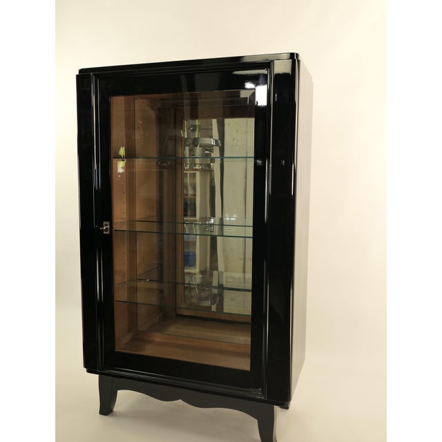 Elegant French Art Deco display cabinet from around 1925. This refined piece has been meticulously restored by hand and...