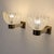 A pair of 1950s Italian wall lamps attributed to Barovier & Toso, featuring a satin-finish brass frame and clear Murano...