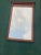 1996 Bombay Company rectangular beveled mirror. Has laurel leaf wreath metal appliqué in center with rectangular metal...