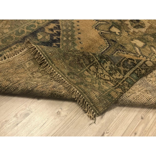 This is a vintage Turkish Oushak rug from the 1960s. The piece was hand-knotted.