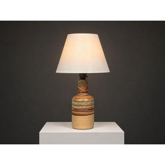 Tue Poulsen, Danish Mid-Century Modern, Table Lamp, Beige Ceramic, Denmark, 1950s A partially glazed stoneware table lamp...