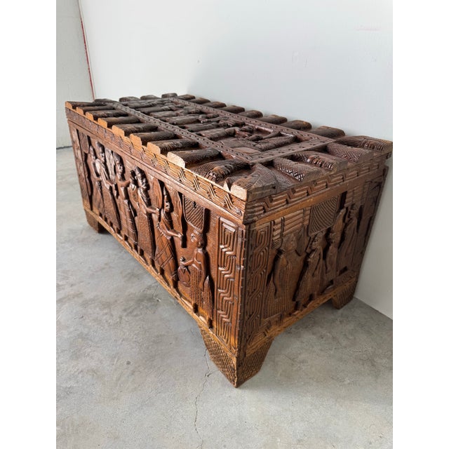 This striking vintage hand-carved wooden chest from Benin, Nigeria is a powerful example of West African sculptural...