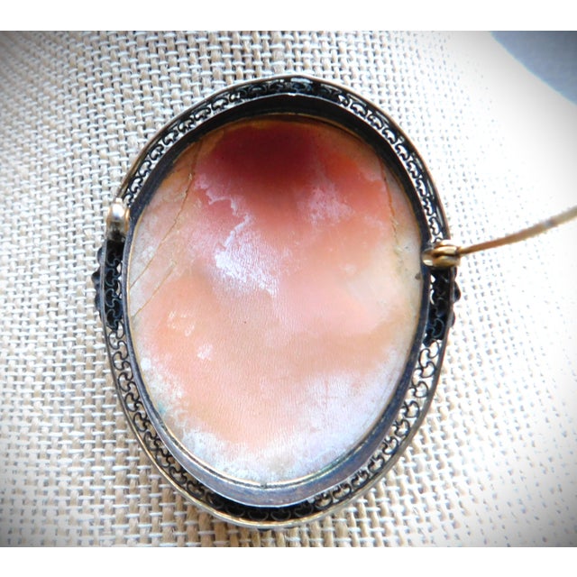 Beautifully Carved Victorian Antique English Cameo Brooch Pin in 10K Pierced and Floral Mounting. The large oval brooch is...