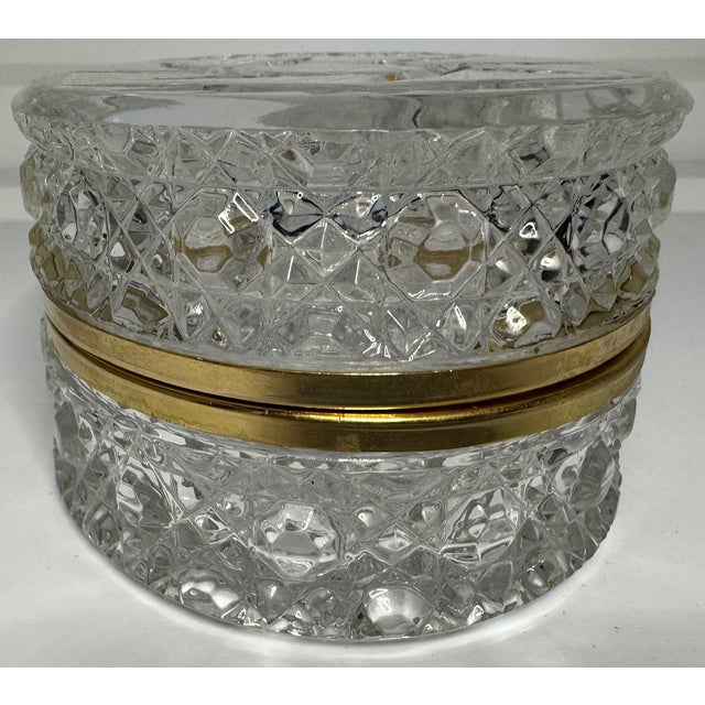 A sparkling cut crystal keepsake box with elegant gold-tone trim—timeless glamour for a vanity or coffee table. Elevate...