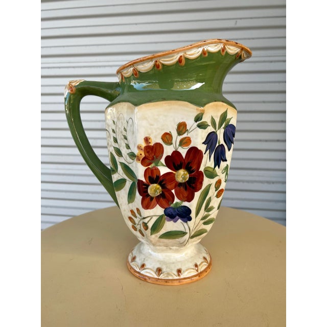 Beautiful colorful Floral ceramic pitcher with green border. Floral Made by Pamela Gladding. Pattern name wildflowers....