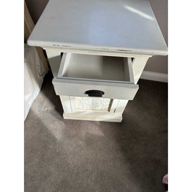 Grange White Wooden Nightstand with Embossed Cabinet Door – Shabby Chic Charm This petite vintage nightstand brings...