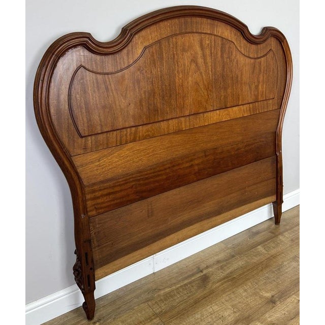 An elegant Antique French headboard in walnut, featuring a beautifully sweeping curved silhouette, warm natural finish and...