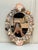 The soft oval shape as well as the varied pastel to earthtoned colors exude throughout this Palm Regency Style mirror. The...