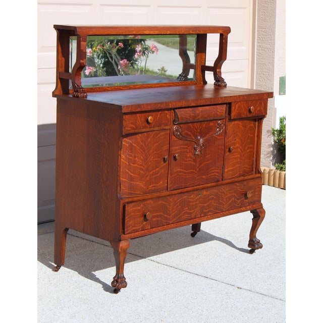 Step back into the grandeur of the early 1900s with this exquisite Antique Victorian Quarter-Sawn Tiger Oak Buffet...