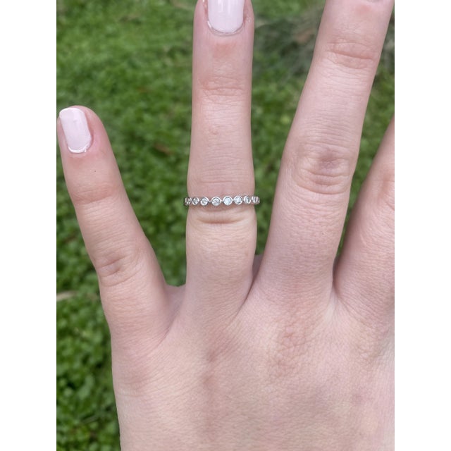 Stones: - diamond - round brilliant cut, 9 stones - 1.75 mm - approximately .18 carat - GH color, VS2-SI2 clarity Ring...