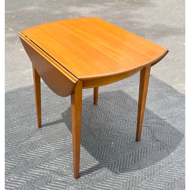 Offered is a beautiful Hitchcock “Apprentice” table. It has a petite footprint taking up only 25” when closed but...