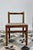 Antique wooden child's chair with a very simple, rustic design, featuring an openwork back and a straight seat. A charming...