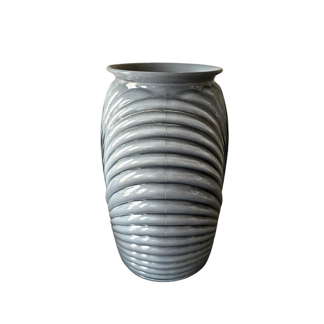 A striking vintage molded art glass vase in a soft smoke gray finish featuring an elegant wrapped ribbed design inspired...