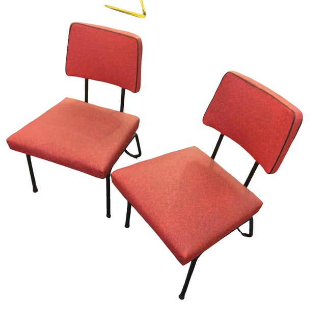 Pair of hip vintage mid century lounge chairs. Brick Red vinyl with black metal accents. Back legs are hairpin style. Low...