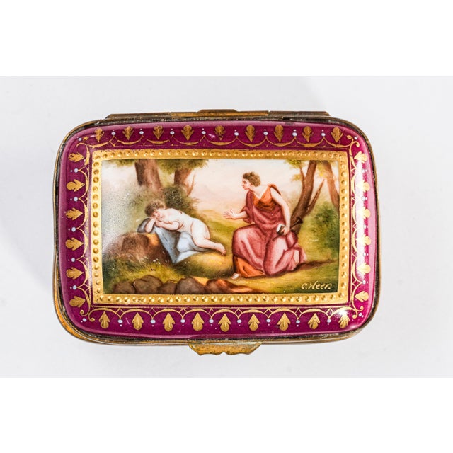 Discover the timeless charm of this beautiful magenta hand-painted porcelain trinket box, a perfect blend of elegance and...