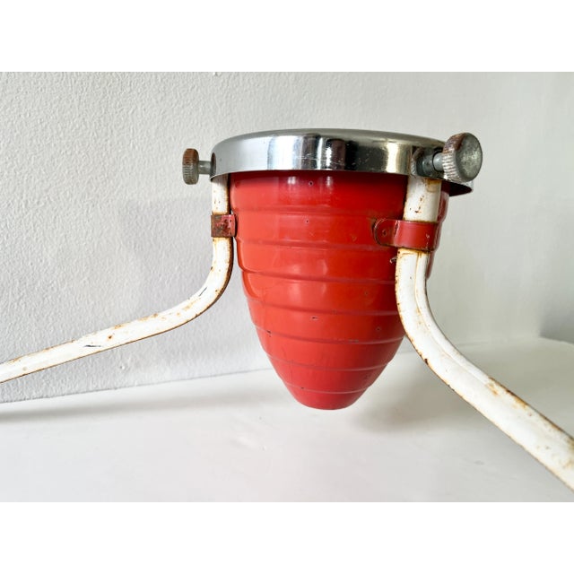 A 1930s Machine Age Christmas tree stand in Art Deco Streamline style. The stand features a red and chrome bullet-form...