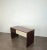 Rectangular-shaped desk made entirely of dark wood and cream enamel with plastic stationery compartment on the top. Made...