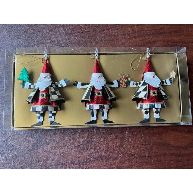 Set of three whimsical Santa Claus ornaments by Mackenzie Childs. These metal ornaments are brand new in the original...