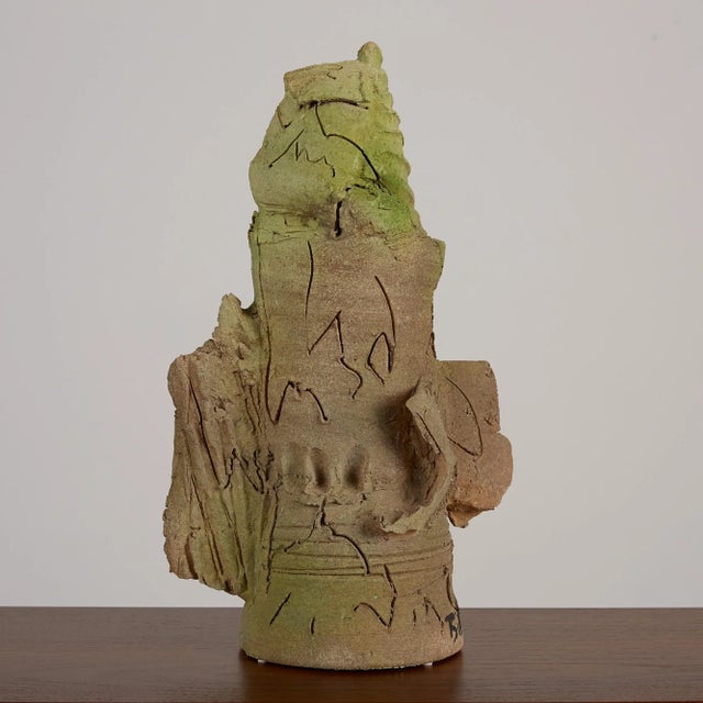 An abstract glazed ceramic sculpture by Stan Bitters, c. 2006, USA. This piece features a ribbed green form at the top of...