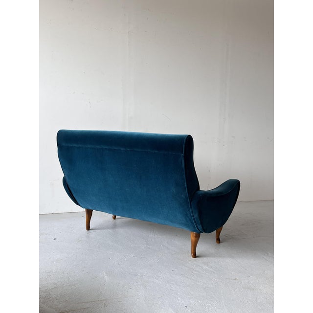 A two-seater Scandinavian sofa made in Norway in the 1950s. Beautiful, irregularly shaped sides. Legs made of solid wood....