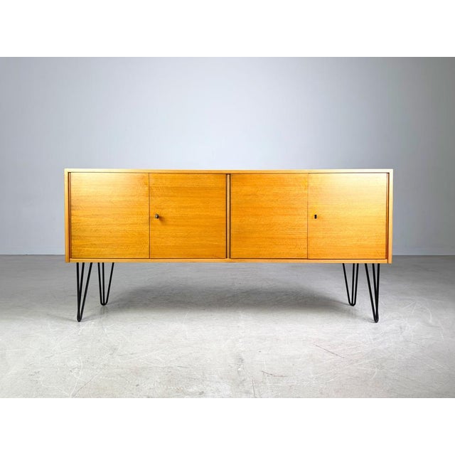 Beautiful vintage sideboard from the 1960s/70s for sale. The piece features four doors, behind which are two storage...