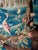 Aubusson (France) wool tapestry depicting greenery enlivened by herons, and a village in an architectural perspective....