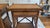 Beautiful vintage pair of British Colonial-style rattan side tables, featuring warm amber wood tones, woven cane/rattan...