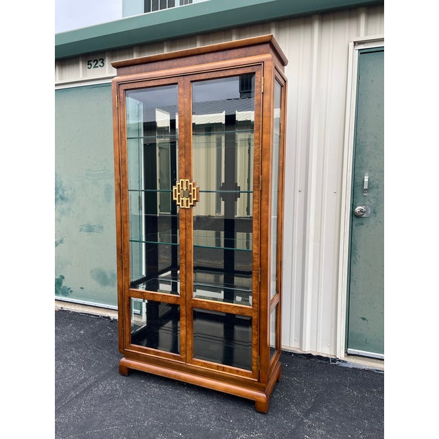 Chinoiserie style Chin Hua display cabinet by Raymond Sobota for Century Furniture. A beautiful burlwood frame encases...