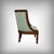 Empire-style gondola armchair crafted from solid mahogany and mahogany veneer. Its graceful curves and rolling backrest, a...