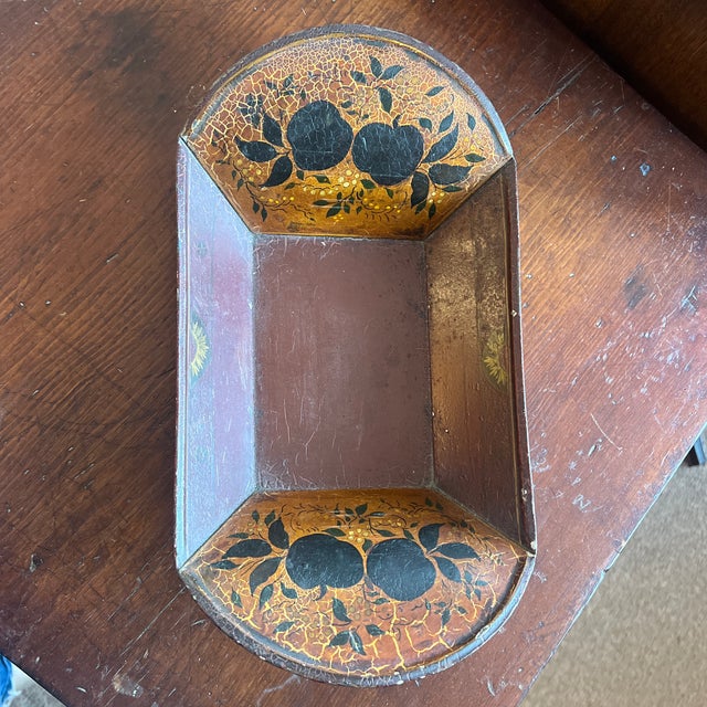 The item pictured is a beautiful example of an antique stenciled toleware bread or apple tray (sometimes called a trough...