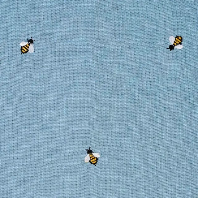 Buzzing with style, this sweet, non-directional design features diminutive honey bees delicately embroidered on a linen...