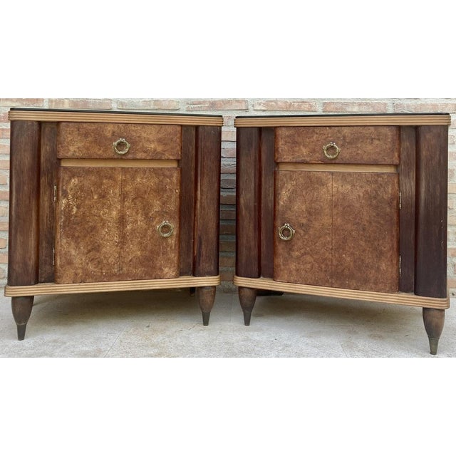 Precious Italian modernist style bedside tables from the 40s, with a black glass top. They have a drawer with a bronze...