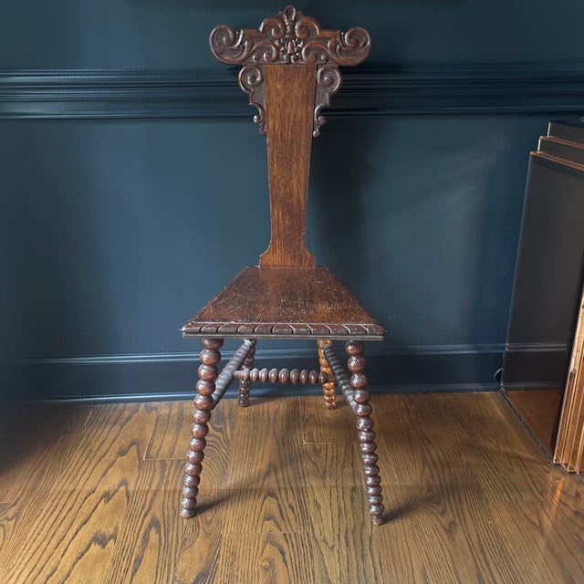 18th century hand carved hall or bathroom chair. Has typical wear throughout but very sturdy. Fantastic piece of artwork