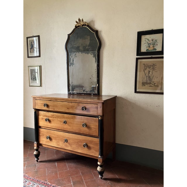 An exceptional early 19th-century Italian Empire cherrywood chest of drawers, masterfully crafted in Lucca (Tuscany)...