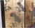 A four-panel double-sided Chinese Coromandel-style folding screen room divider with a black lacquered frame bordered by...