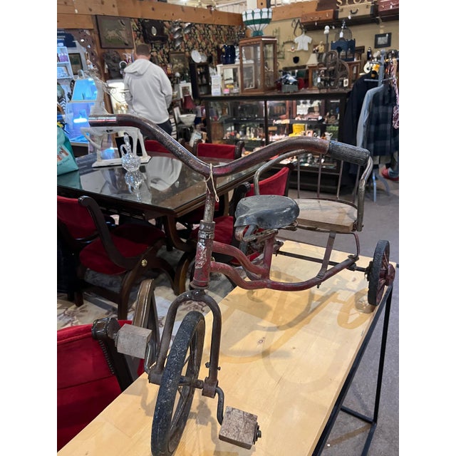 This charming vintage metal child’s tricycle with rear passenger seat, featuring a beautifully aged red painted frame and...