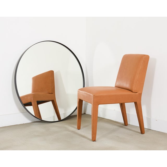 A modern contemporary round "Bristol" wall mirror by RH (Restoration Hardware) crafted from aluminum and blackened...