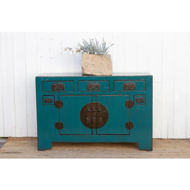 This breathtaking Chinese elm credenza whispers stories of the Qing Dynasty. Handcrafted from solid elmwood, it exudes a...