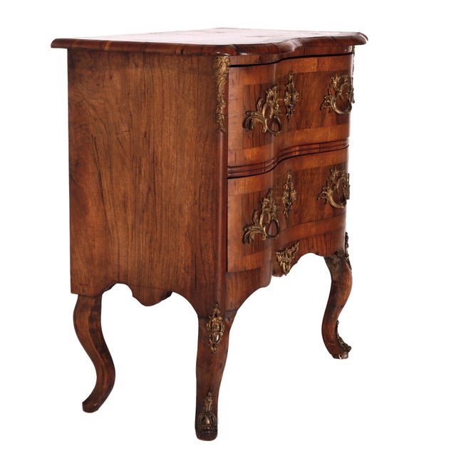 An antique Italian side chest offers kingwood construction with satinwood inlay having shaped top over serpentine case...