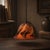 An Ethereal Interplay of Light and Liquid Fire The Description: Add an organic, dramatic glow to your space with this...