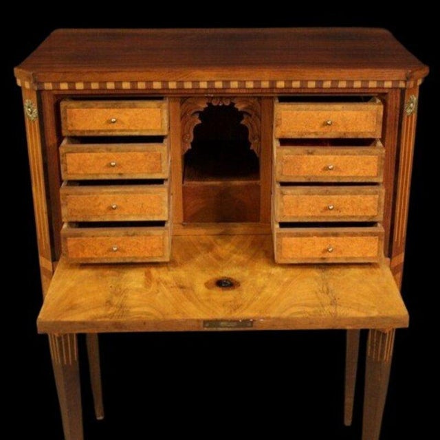 A louis xvi style bargueno secretary desk in marquetry of precious woods, circa 1900-1920. The woods are walnut, rosewood,...