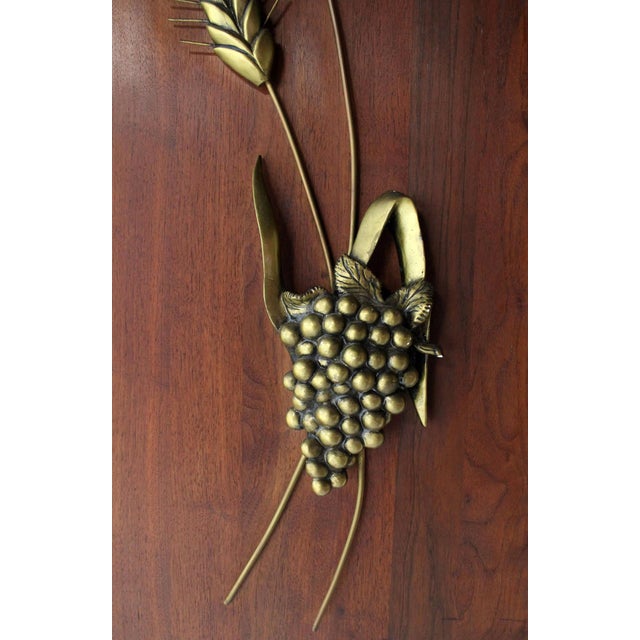 Pair of solid cast metal sculptures of wheat, grapes, apple, pear and cattails mounted to solid walnut board.