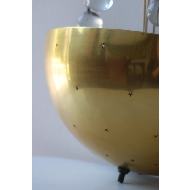 A charming pair of mid-century American wall sconces in the manner of Paavo Tynell, manufactured by Jay Lite Mfg Co. of...
