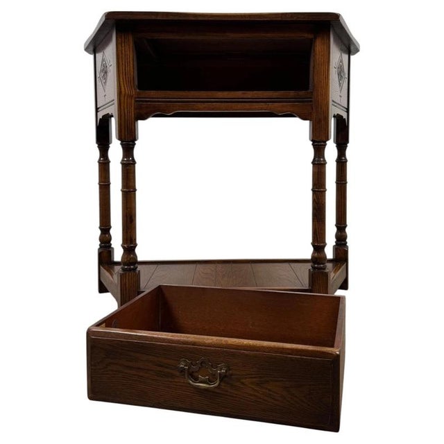 A charming early 20th-century English side table, finely crafted from oak and distinguished by its turned legs, subtle...
