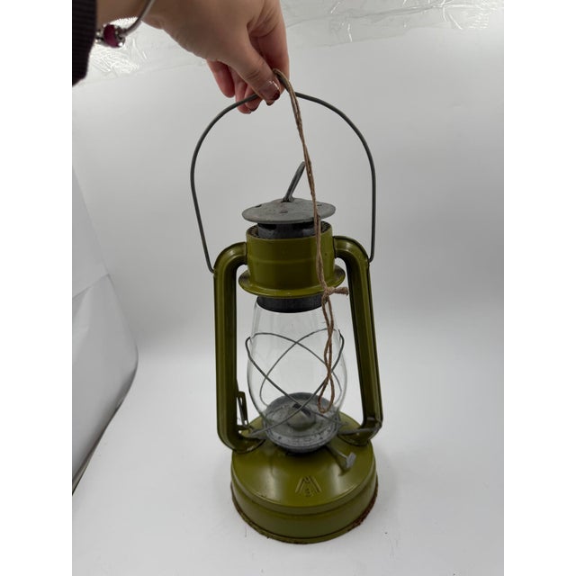 Classic kerosene/storm lantern (kerosene lamp) in a cool retro green, metal casing with glass burner and handle. Height...