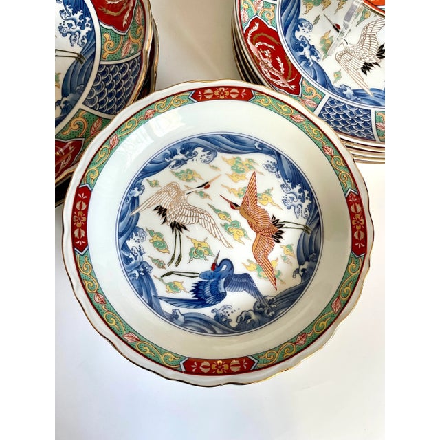 Listed here is an elegant Japanese dinnerware and serving set featuring hand-painted cranes and intricate Asian designs...
