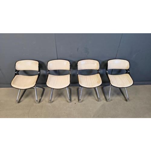 Set of 4 seventies dining chairs designed by Etienne Fermigier and produced by Baumann. The chairs have a plywood frame...
